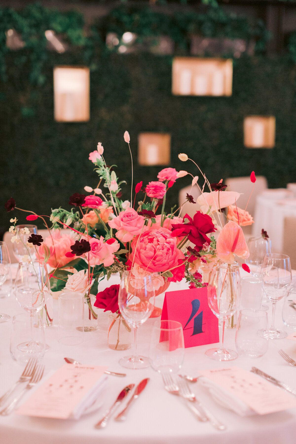 Tropical floral centrepieces of pink flowers for a wedding reception at Restaurant Beatrice.