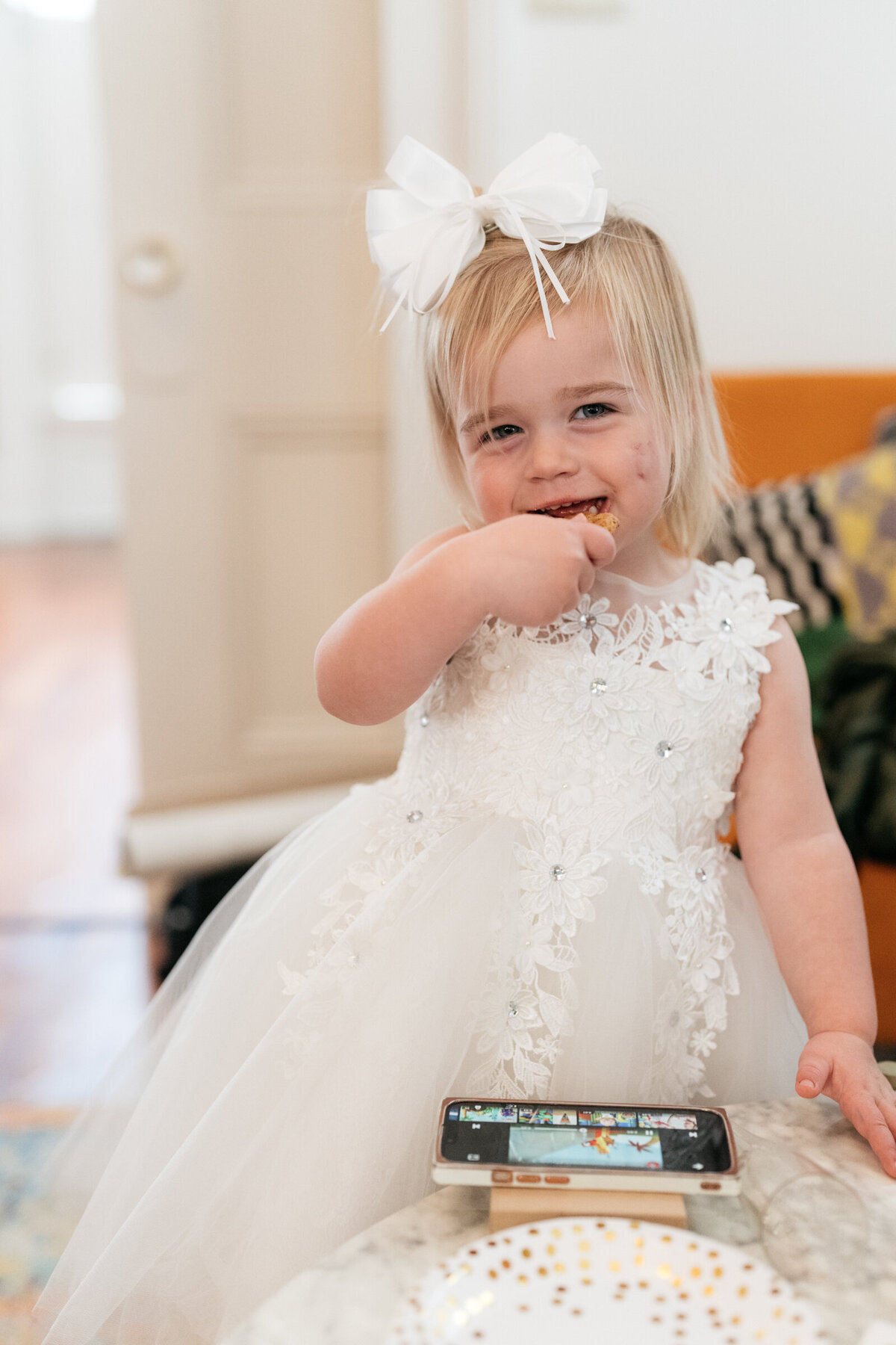 flower girl eating a cookie