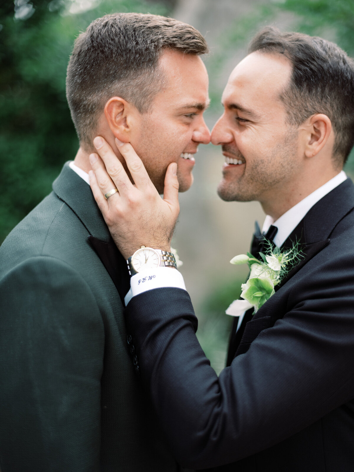 A heartwarming scene featuring two grooms sharing a joyful moment, capturing the essence of love and commitment against a lush, green backdrop, perfect for weddings.