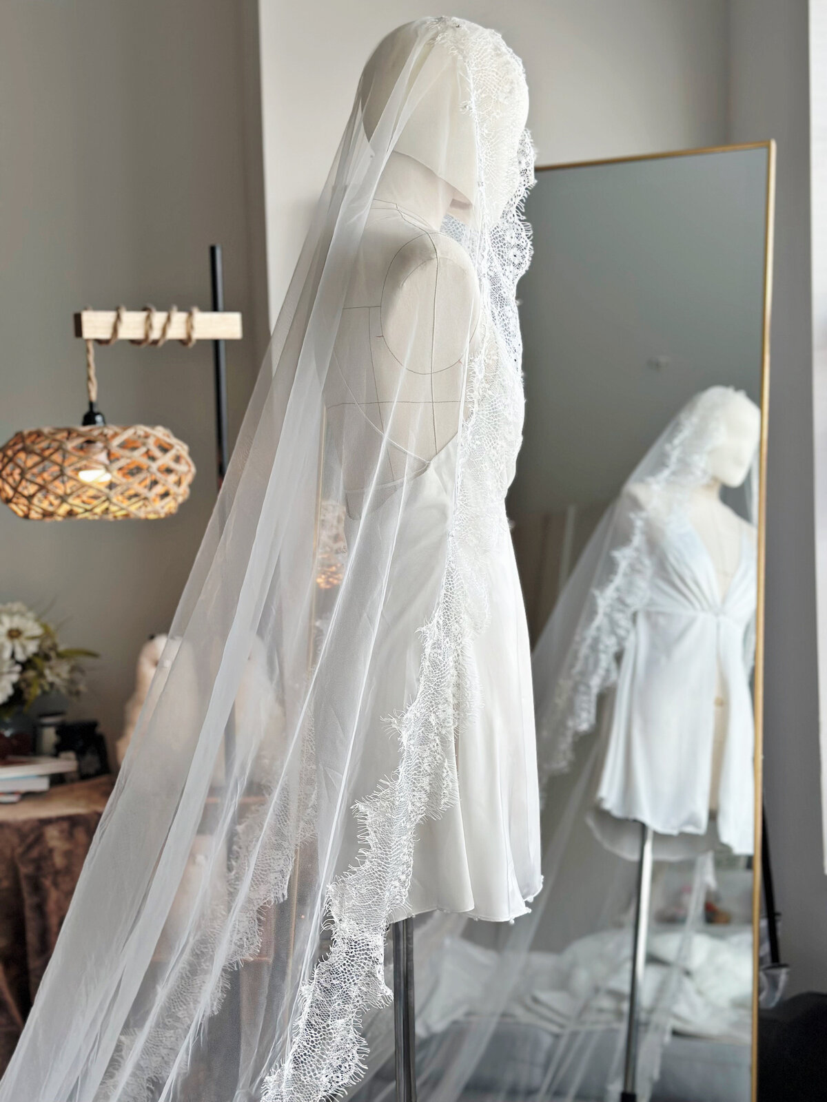 Side profile of bride wearing long lace mantilla veil