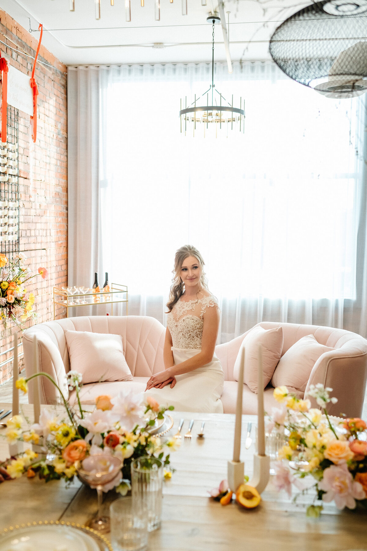 Stunning bride sitting  behind table decorated by Modern Rentals, contemporary decor rentals based in Calgary, AB. Featured on the Brontë Bride Vendor Guide.