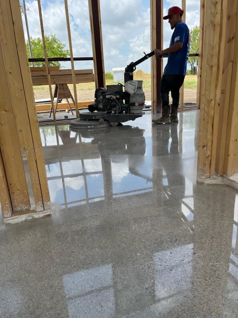 Affordable Residential Concrete Polishing in DFW, showcasing a polished concrete floor in a home, demonstrating cost-effective and high-quality flooring solutions.
