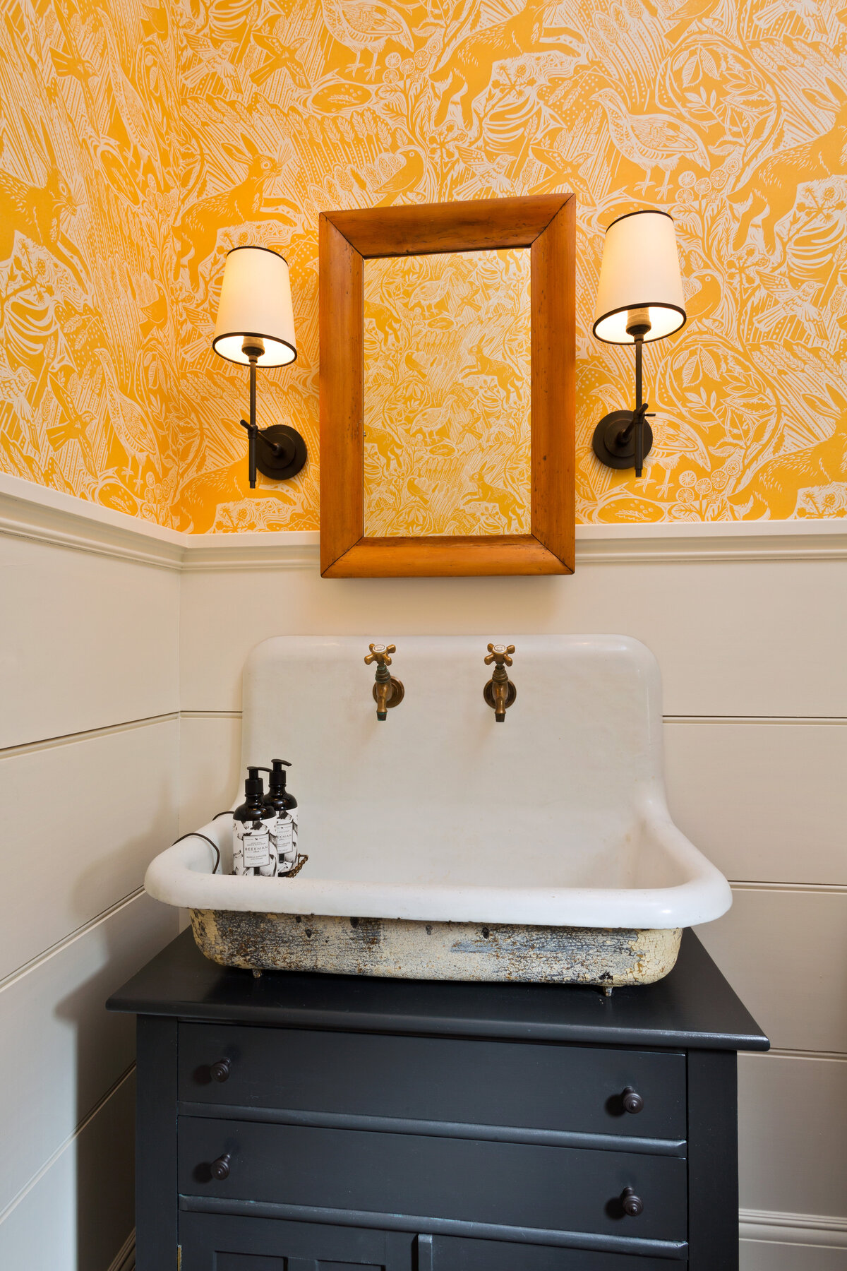 guest bath with yellow accent wallpaper 