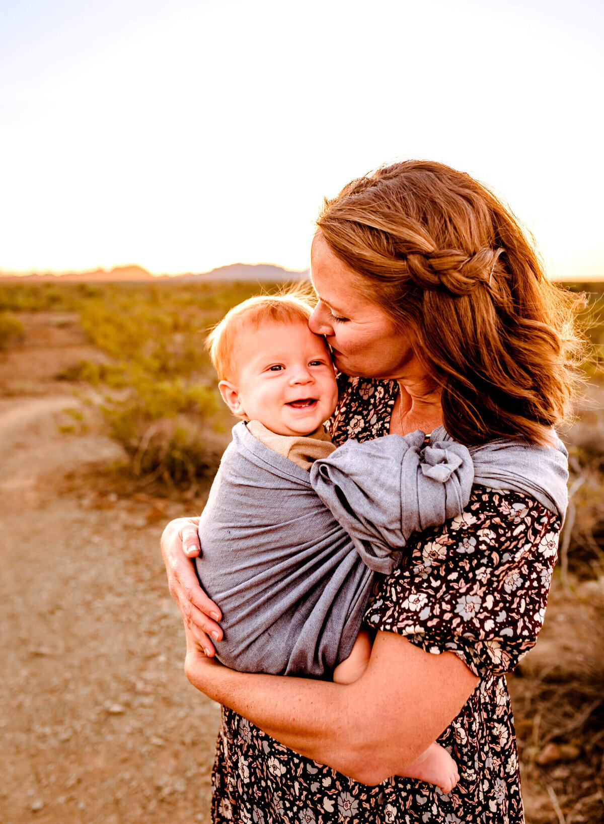 mom wearing her baby during family session captured by Arizona photographer