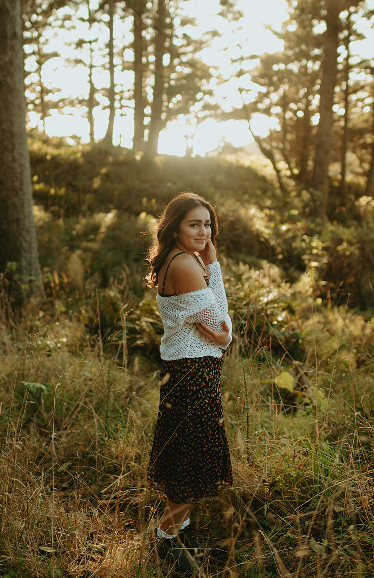 Girl standing in forest field posing for the camera