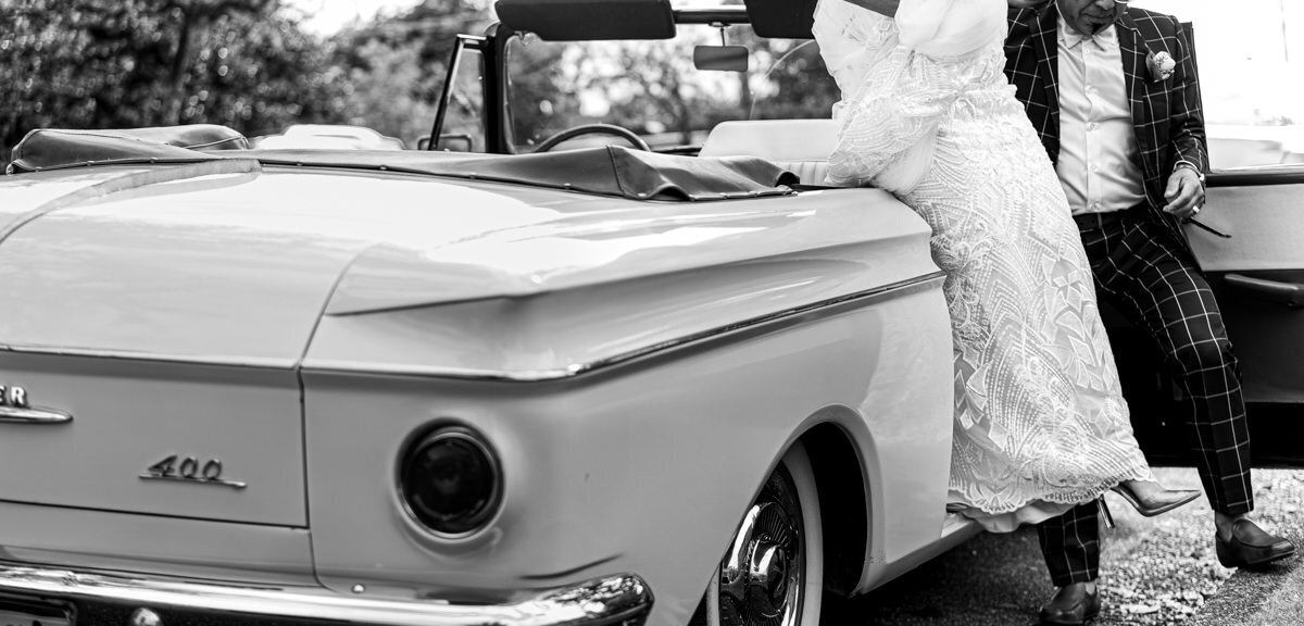 dad helping bride out of vintage car