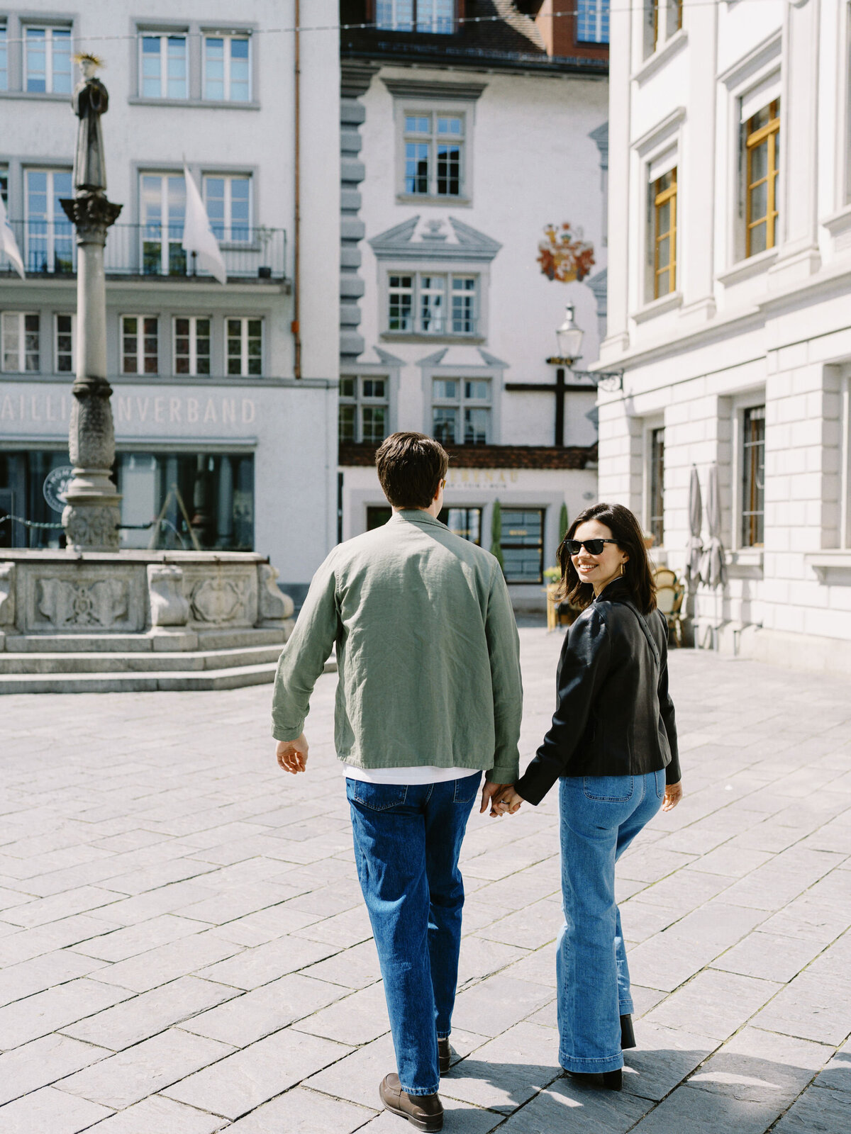 A couple walks through the streets of Lucerne, Switzerland on their engagement session