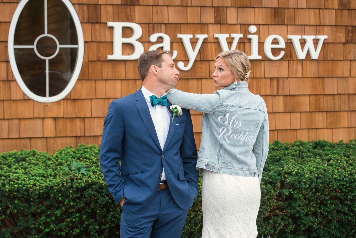 Bride and groom posing outside Bayview House at Captain Bills