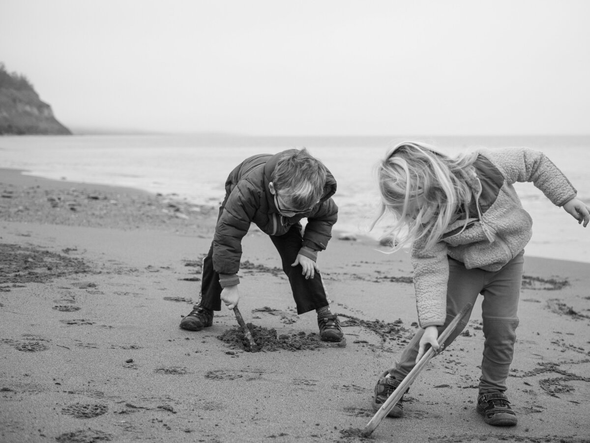 two children playing in the sand  in the PNW