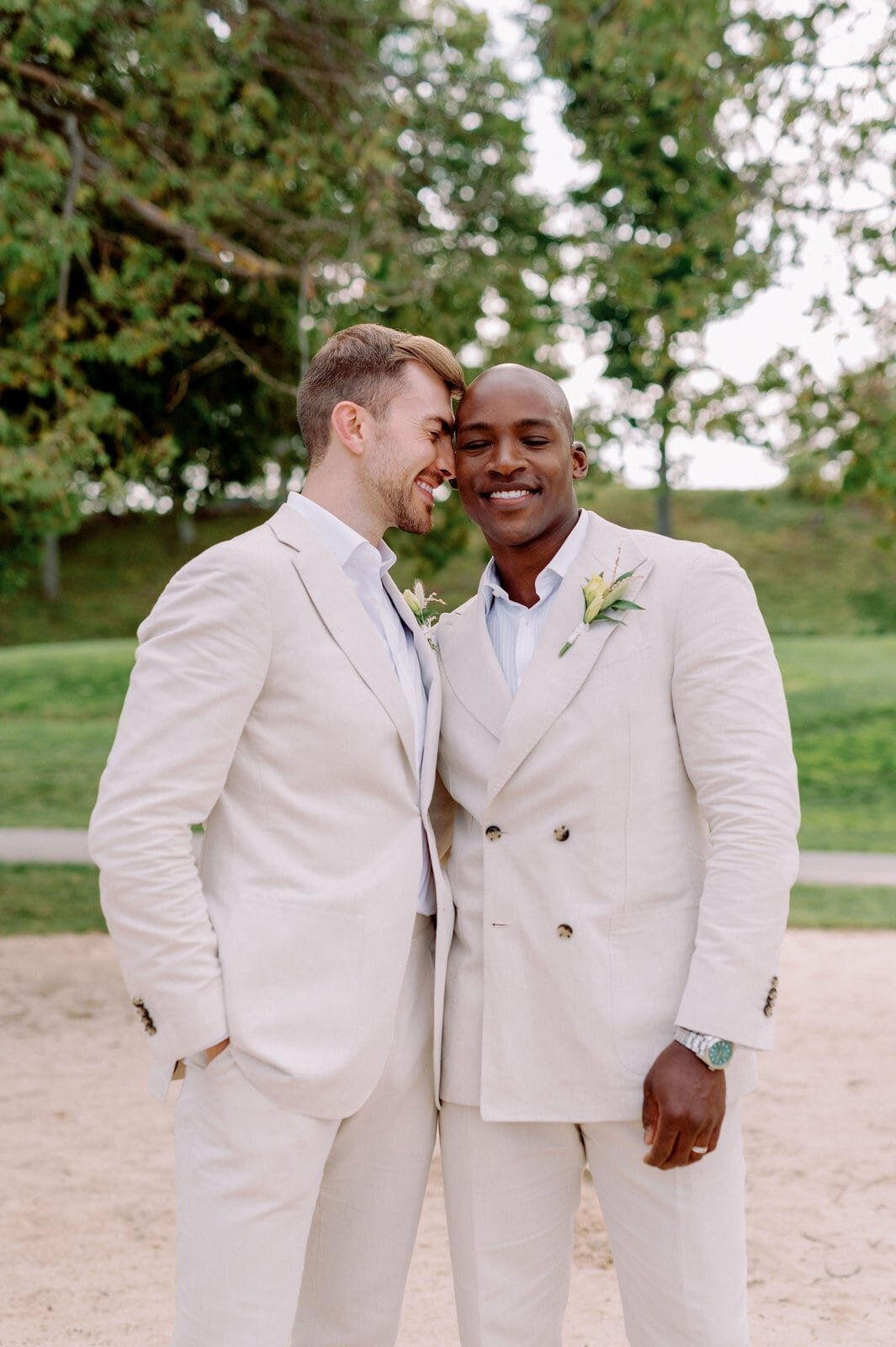 Interracial gay groom and groom wedding lgbtq happy in love at the beach muskoka lakes golf and country club jacqueline james photography