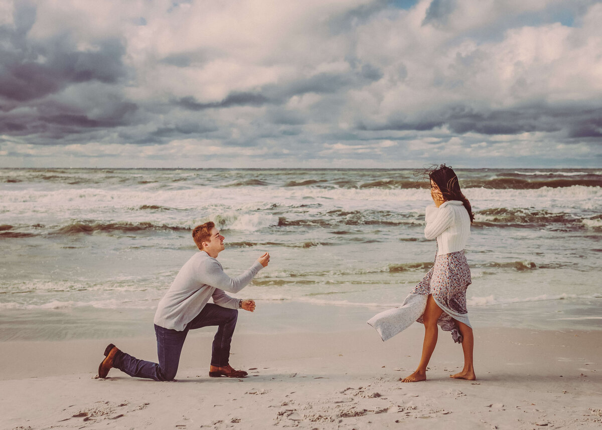 man on one knee proposes to girlfriend in panama city beach