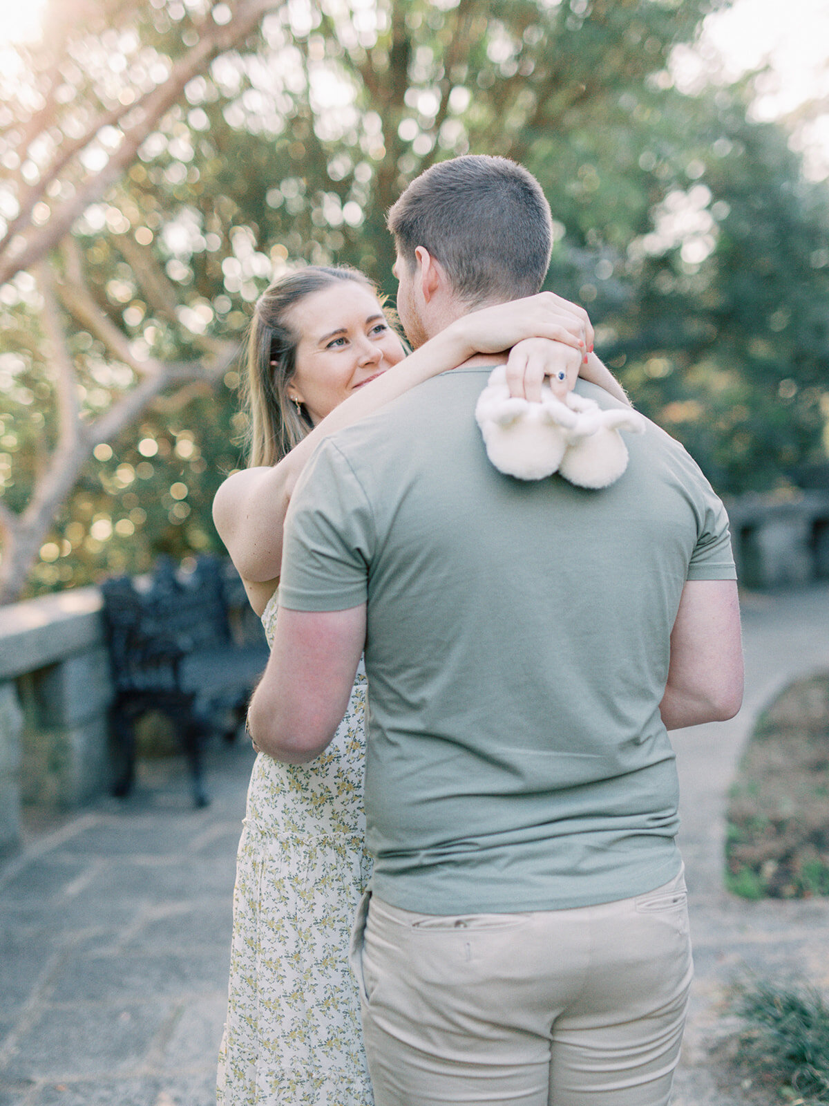 A couple looking at each other while the mother holds baby slippers during a Richmond maternity photography session by Katie Stansfield Photography.