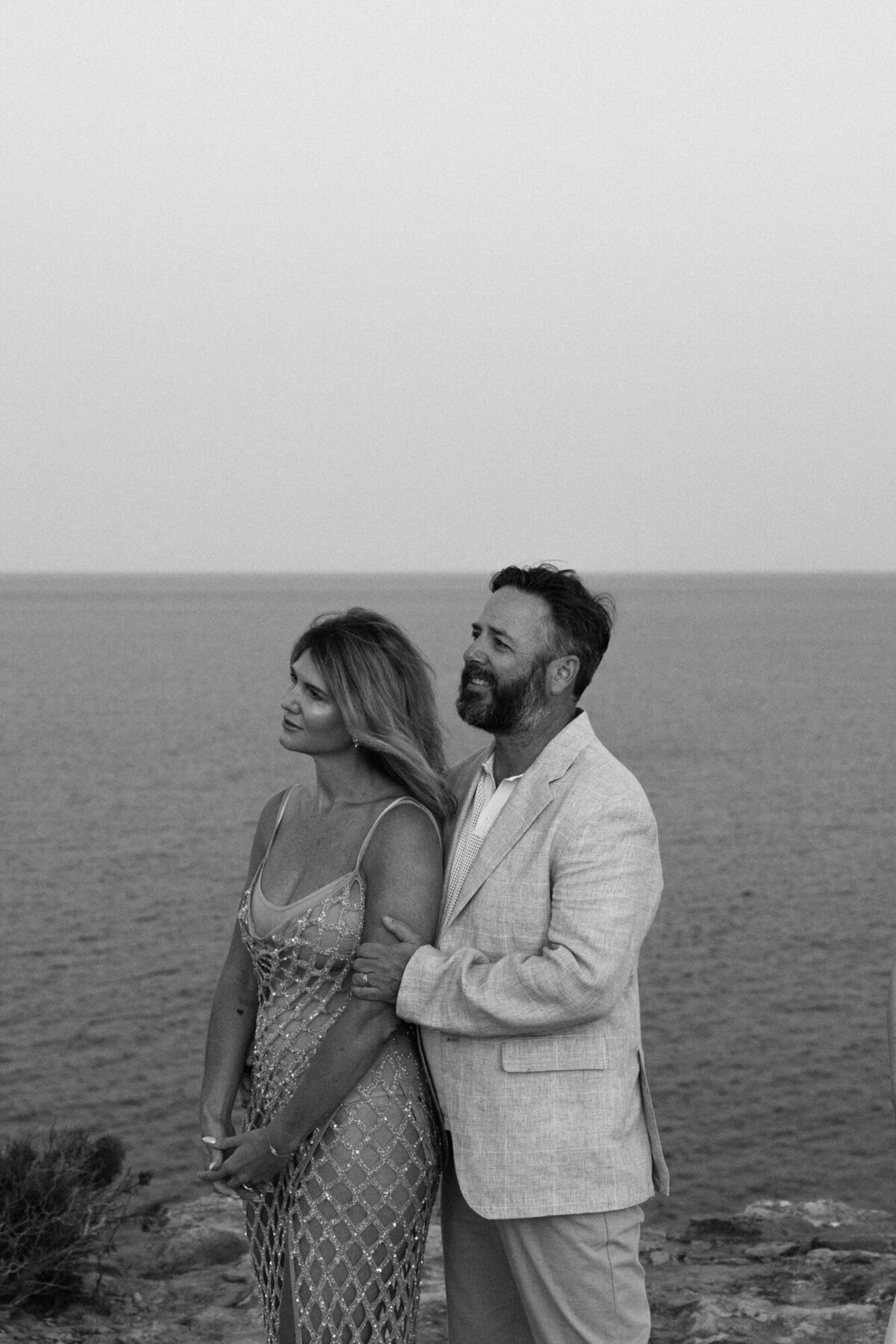 Couple touching each other in front of the sea on Ibiza during an Ibiza elopement
