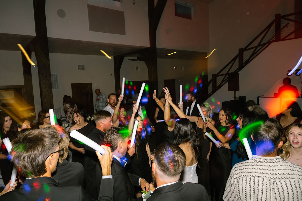 Guests dancing with glow sticks