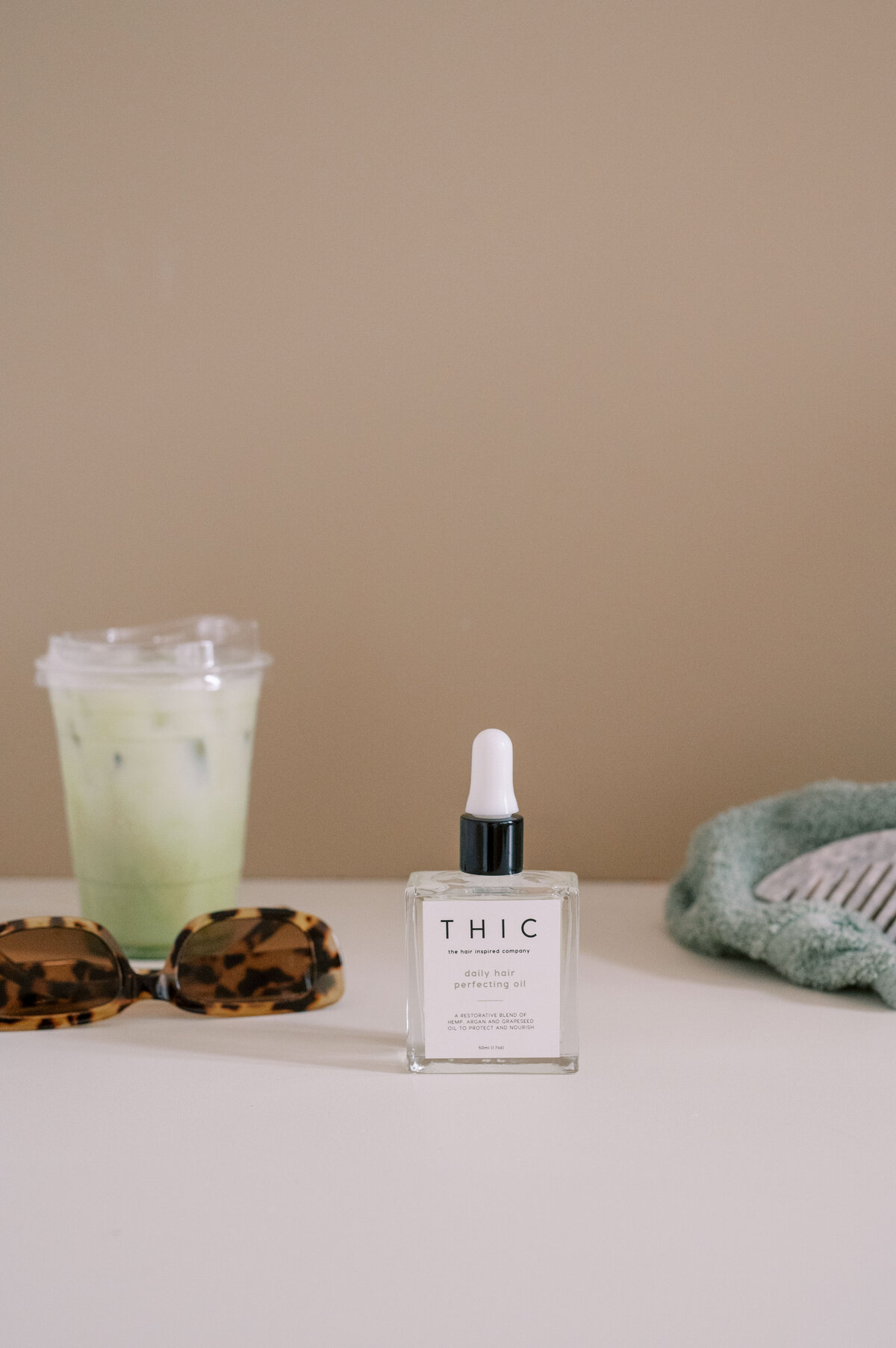 THIC hair products with latte and sunglasses