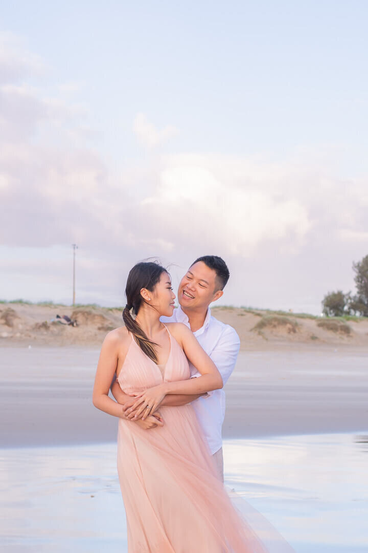 beach portraits with pastel sunset at the spit engagement