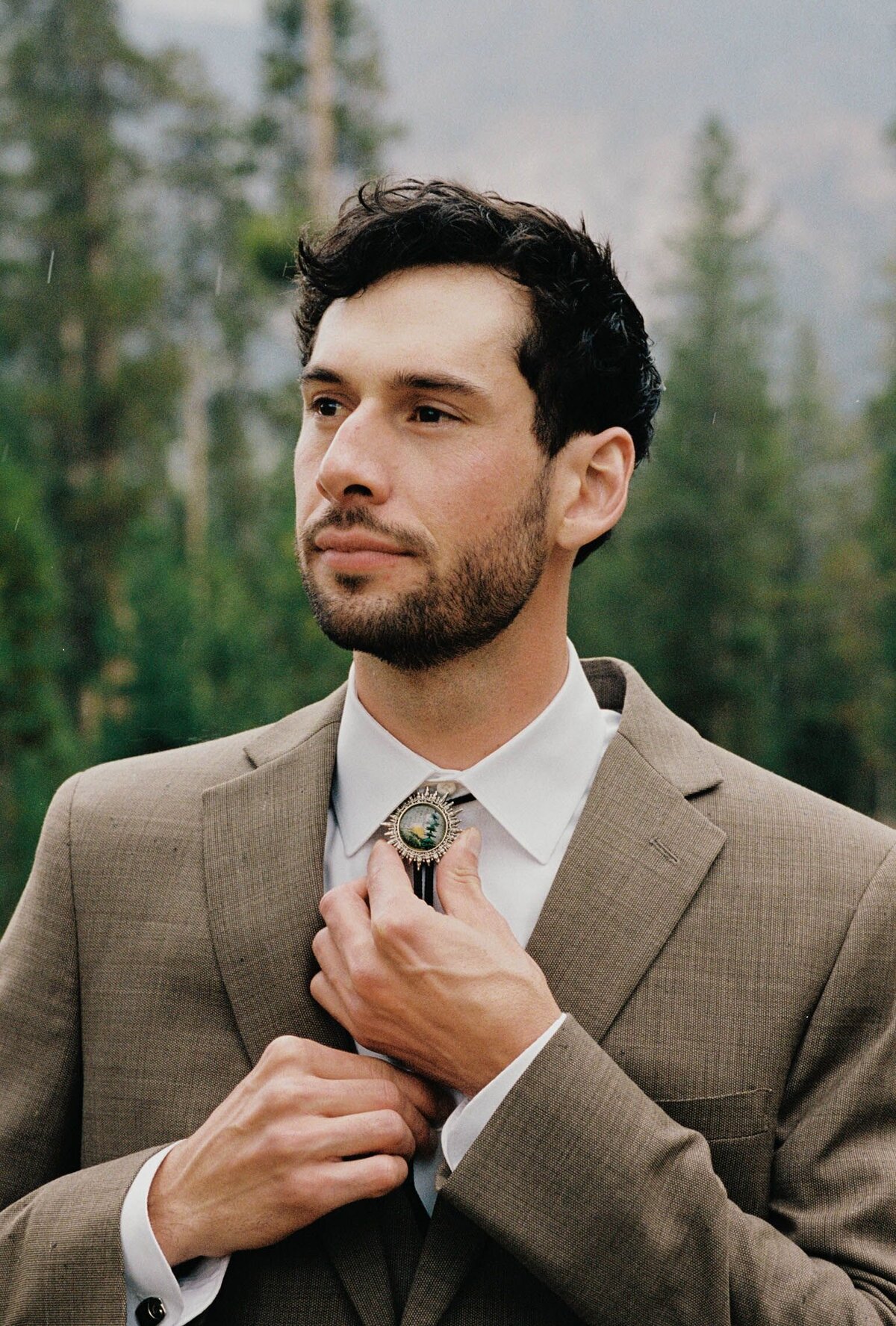 groom adjusting bolo tie