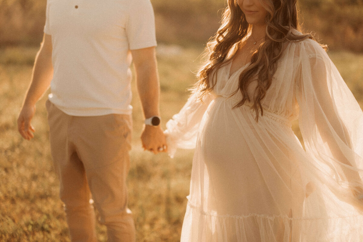 Expecting mother standing in soft light during Franklin TN maternity studio session