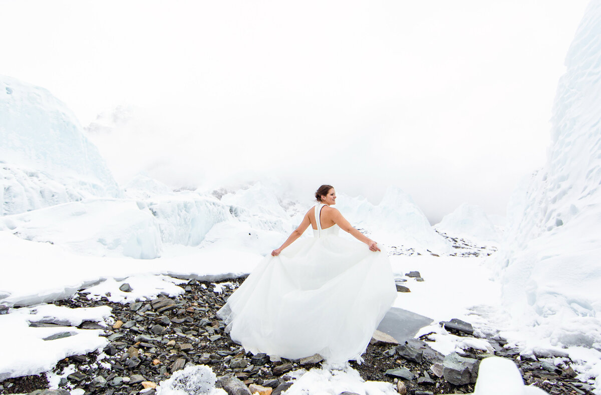 The beautiful bride twirls in her wedding gown amidst the ice formations of the Khumbu Icefall at Everest Base Camp in Nepal