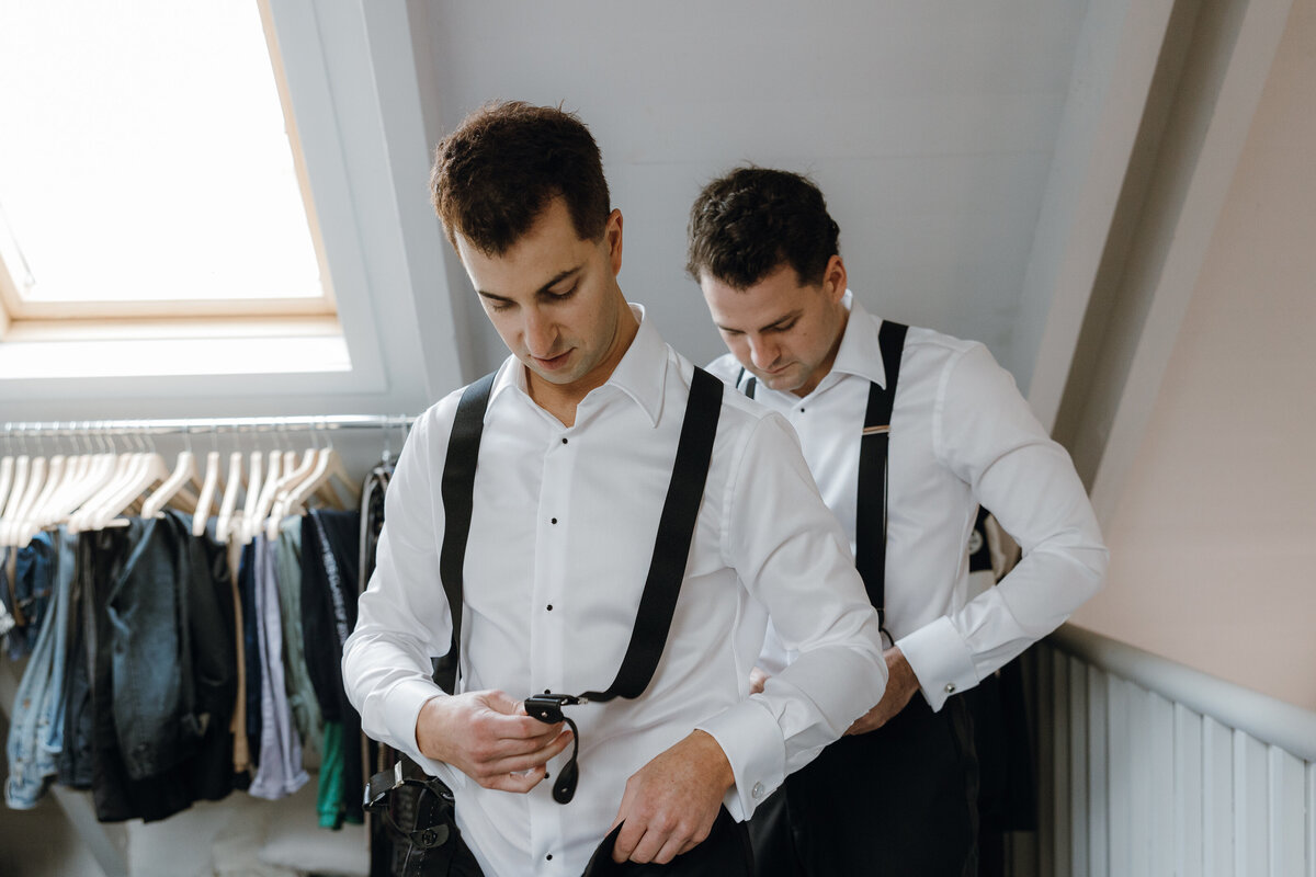 2 grooms wearing suspenders for their wedding.