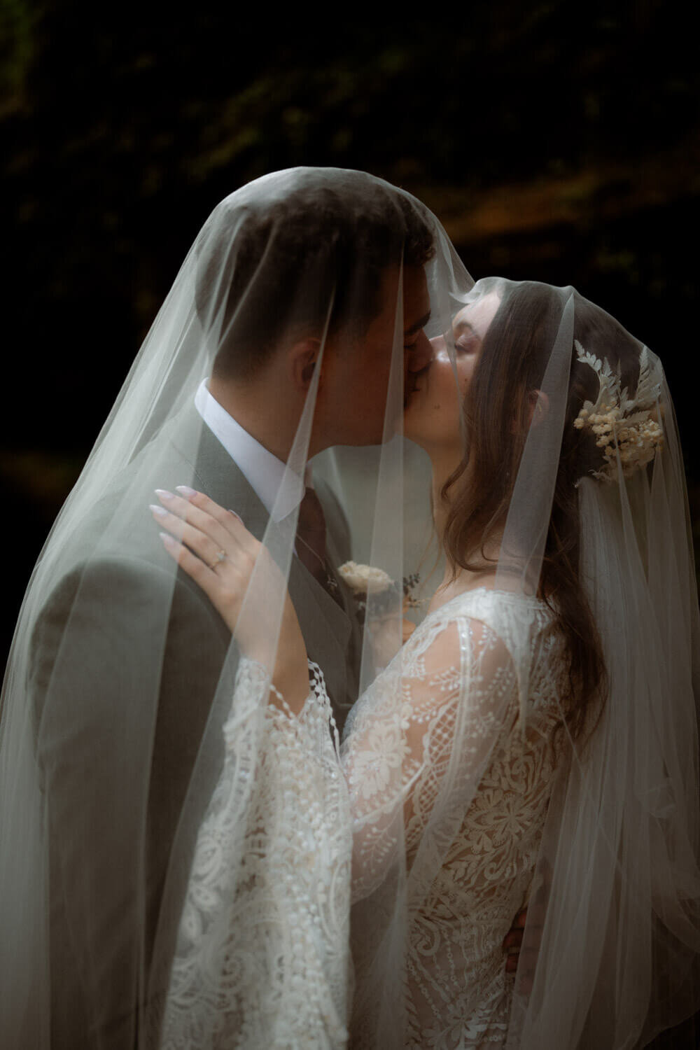 Couple smile underneath veil for fantasy woodsy inspired elopement