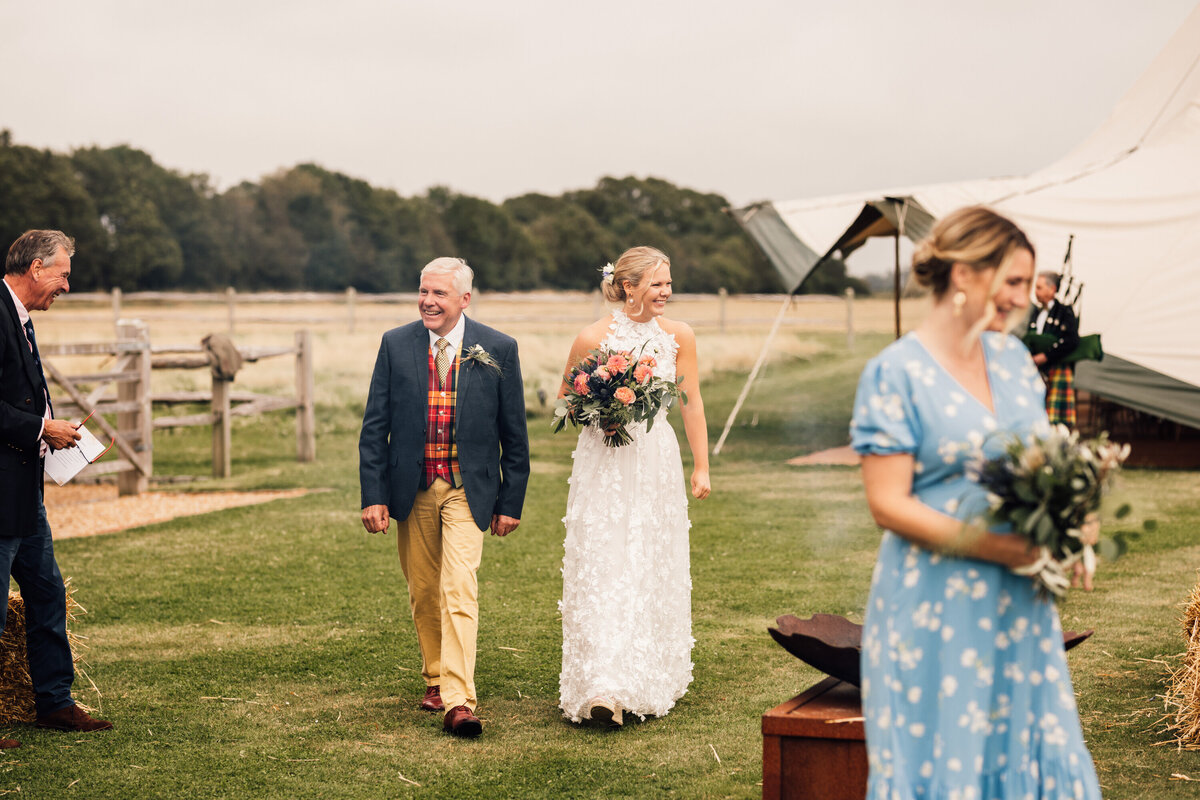 Father walking bride down the aisle at outdoor countryside wedding