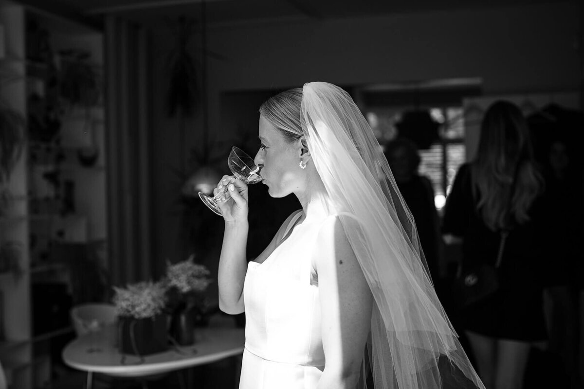 Bride driking champagne in london home