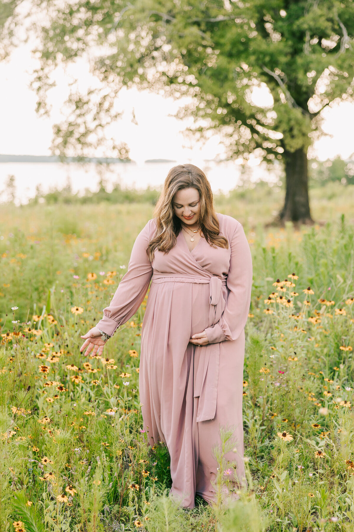 Expecting mom holding her baby bump during her augusta maternity portrait session