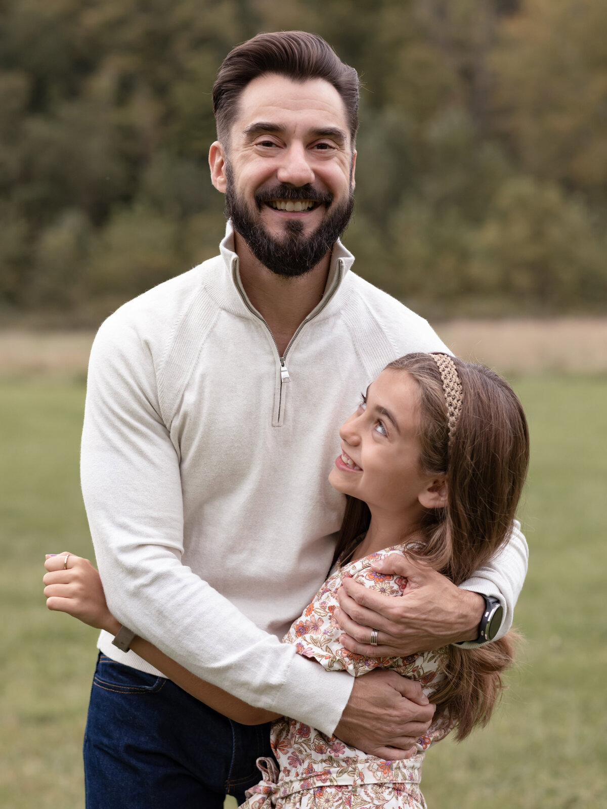 dad hugging daughter for family photos