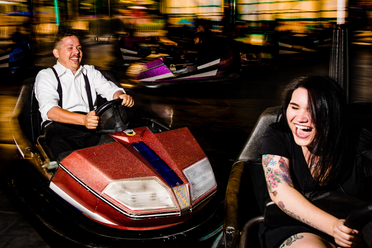 Engagement photos at the Michigan State Fair. The couple crash into each other in bumper cars during these fun engagement photos.  Photo By Adore Wedding Photography. Toledo Wedding Photographers