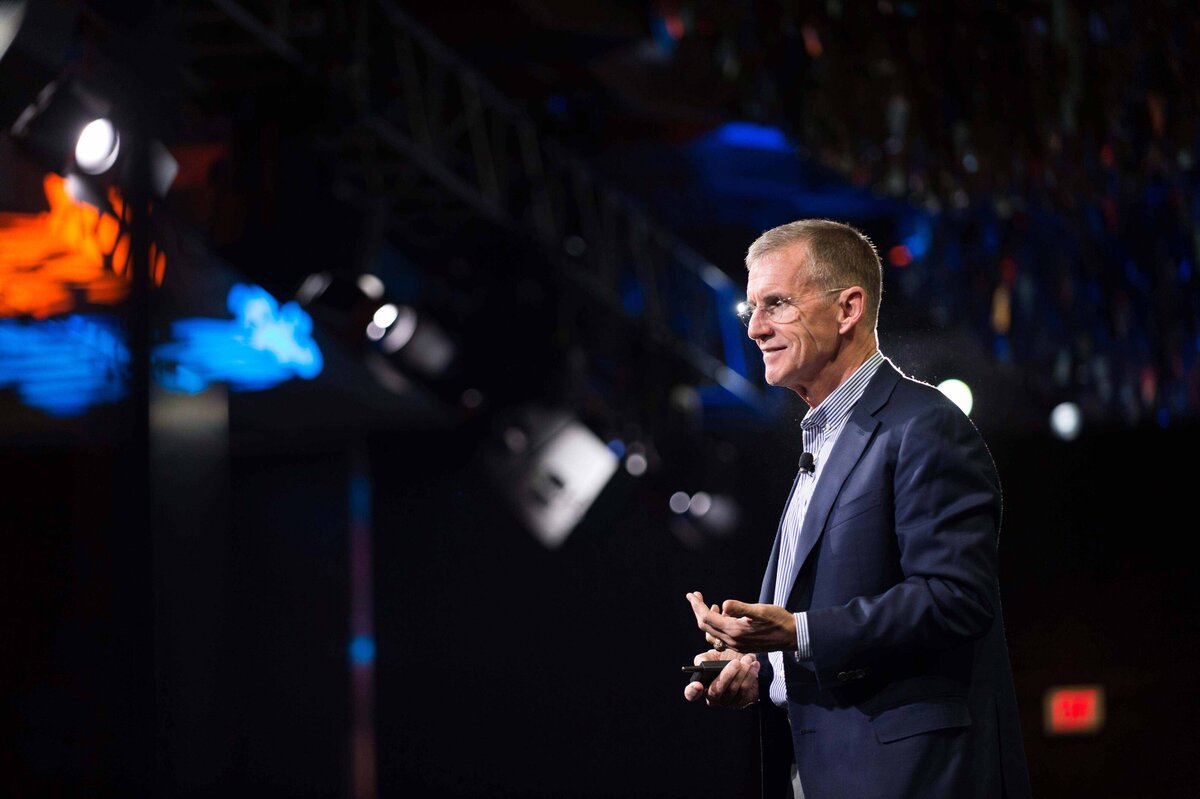 Stanley A. McChrystal onstage while he explains strategies for overcoming new organizational challenges