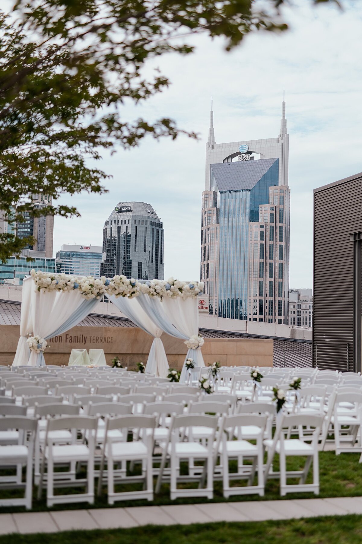 Blue and white wedding arbor with Nashville skyline at Country Music Hall of Fame