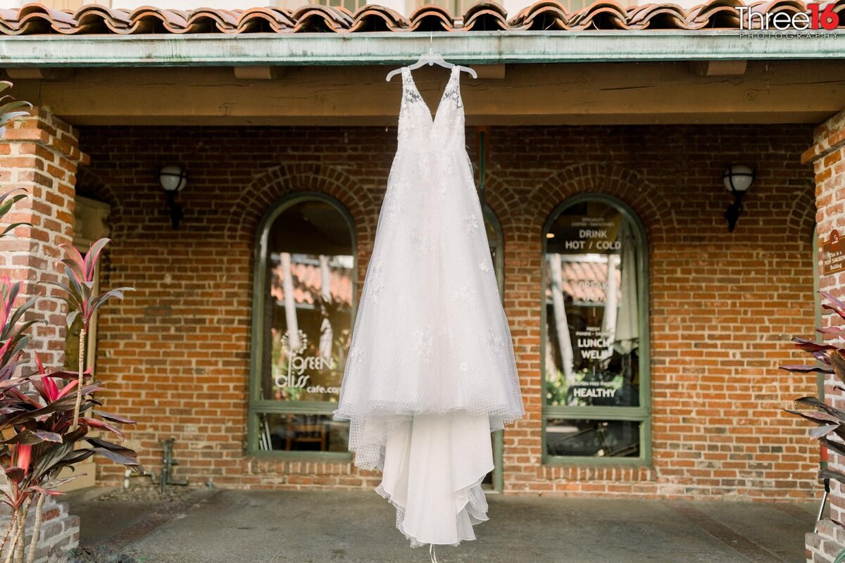 Bride's wedding dress hangs on display