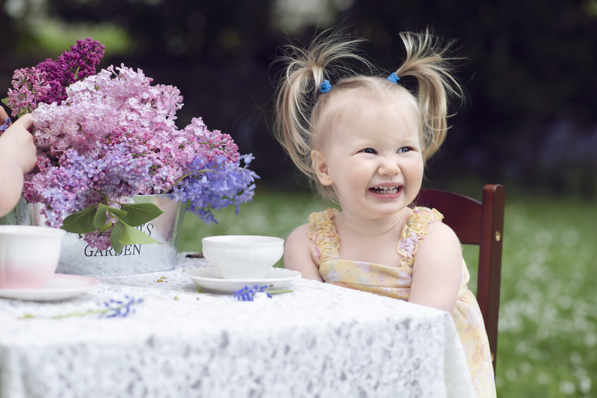Girl laughing while having a tea party