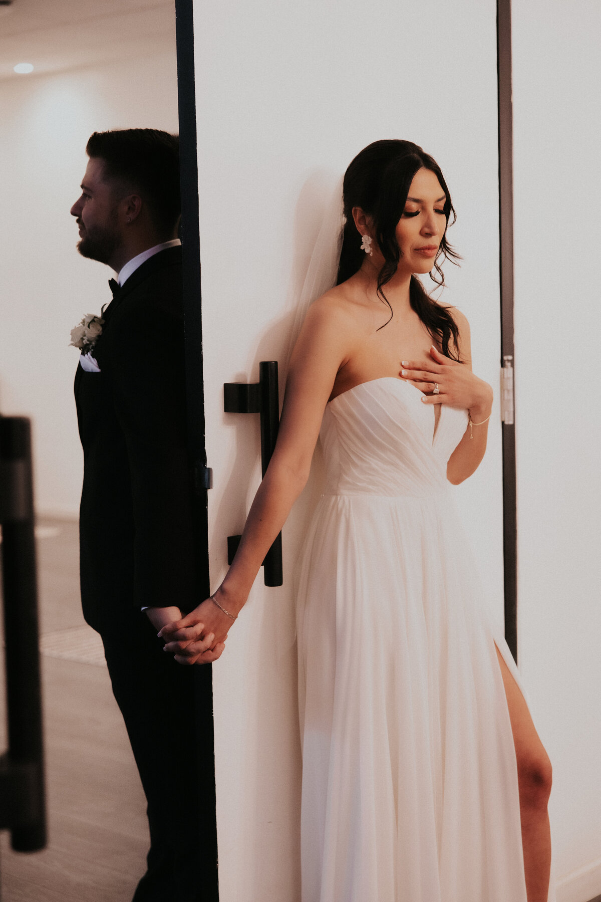 Bride and groom holding hands in bridal suite of the croft downtown wedding venue