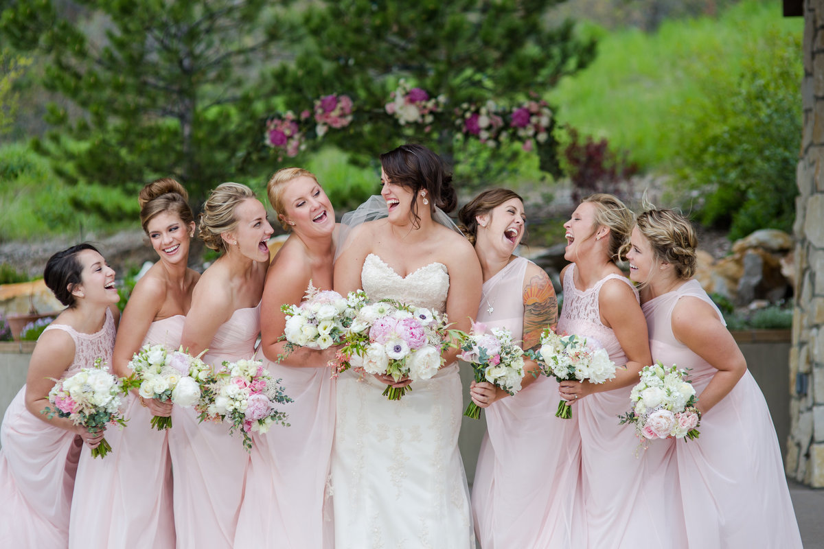 bridesmaids laughing with bride