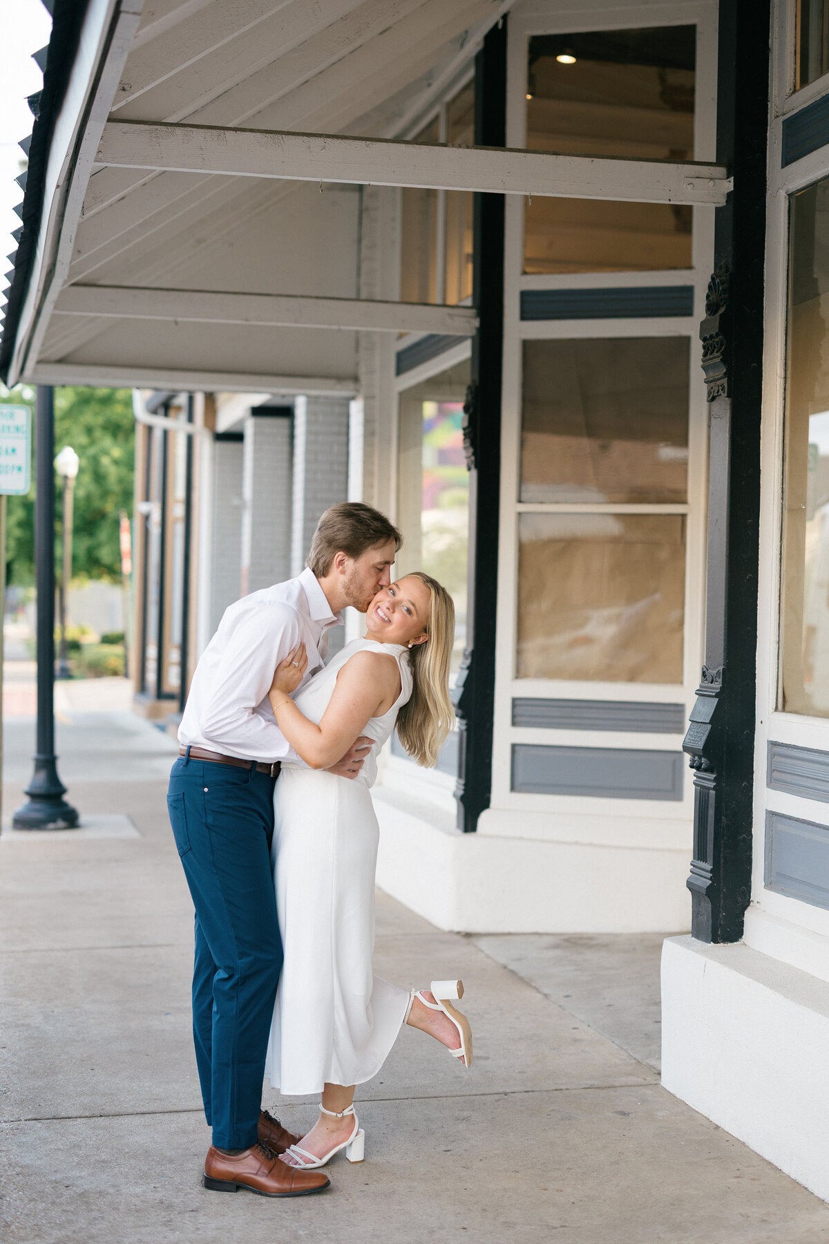 Downtown Bentonville Engagement Session – Couple Kissing in City Streets