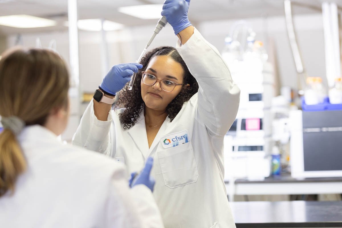 Student pipetting liquid into a test tube
