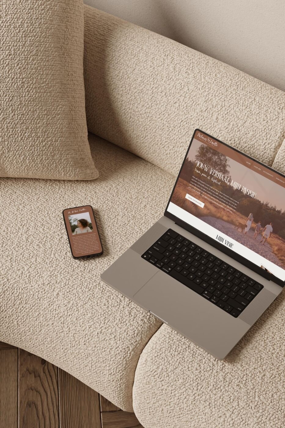 Laptop and smartphone side-by-side on a cream textured couch, both displaying the Pictures by Lisette Photography website; laptop shows a family walking on a sunlit path, while phone shows an about page with a portrait of the photographer.