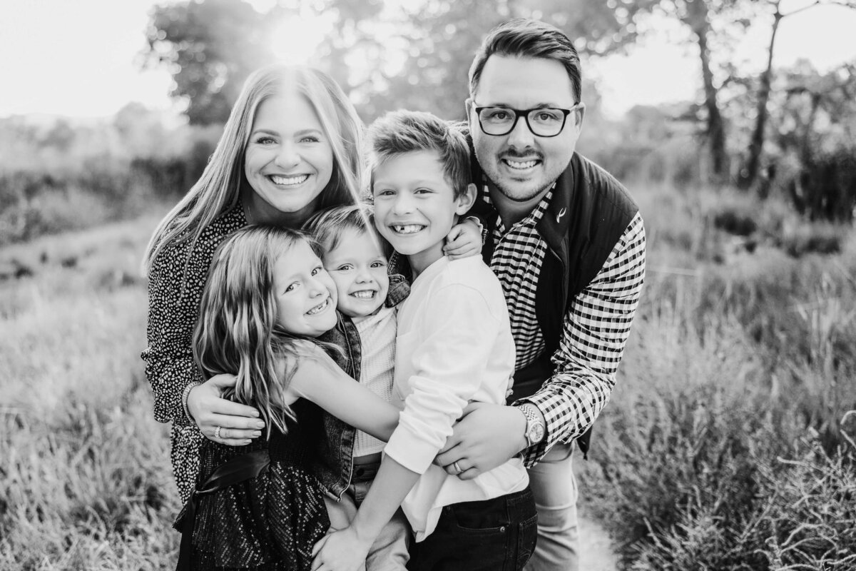 Black and white  image of a family snuggled together in northern colorado