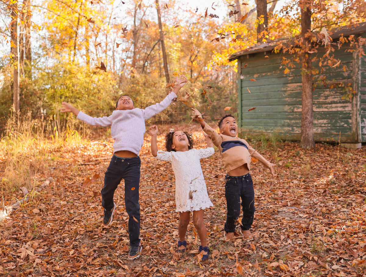 kids playing in leaves by Columbus Georgia family photographer Amanda Richardson Photography