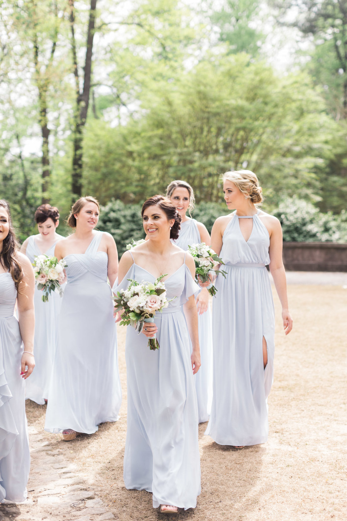 These bridesmaids dresses flowed so beautifully as they walked through the Swan House gardens. Photo by luxury destination wedding photographer Rebecca Cerasani.