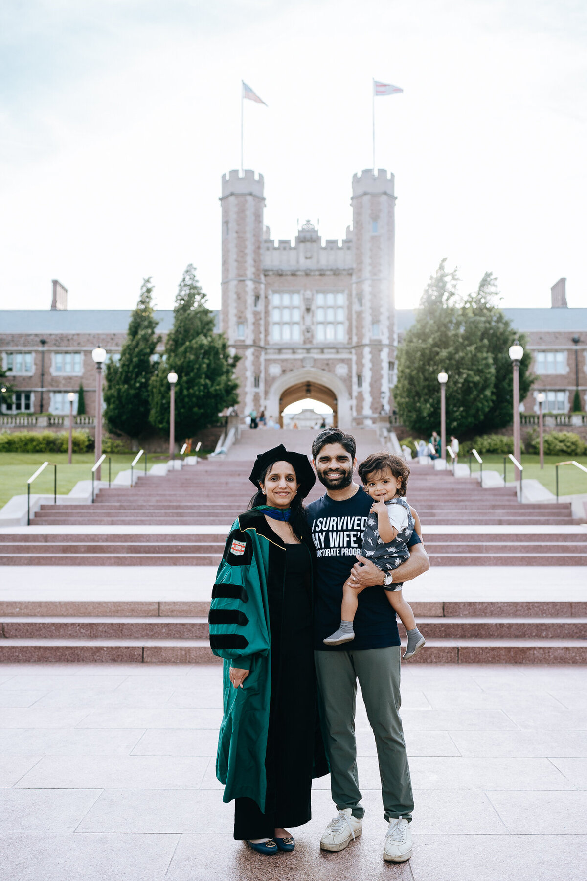 family of three posing at the steps of brookings hall