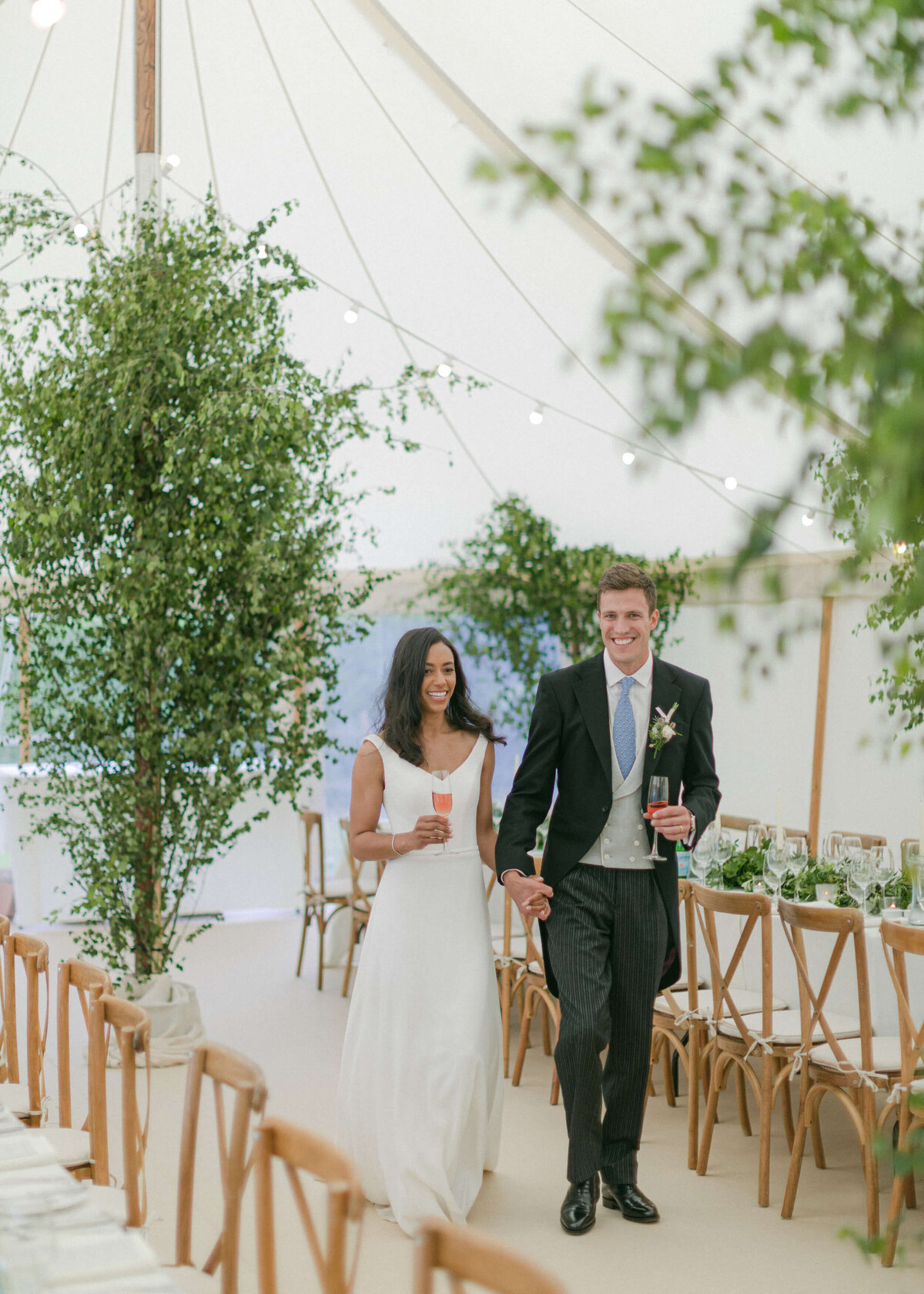 chloe-winstanley-weddings-bride-groom-walking-sperry-tent-tablescape