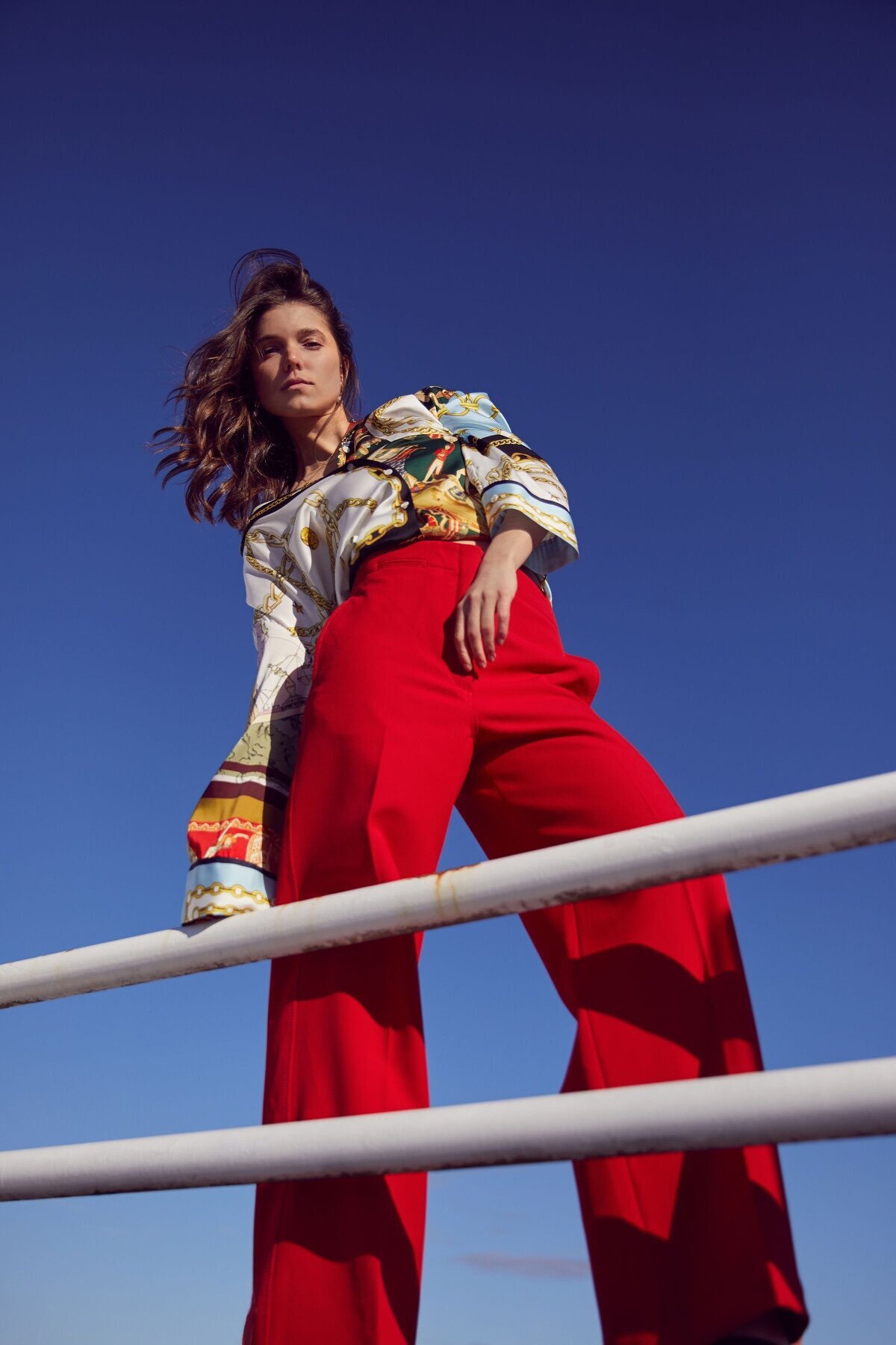 Picture of girl in red pants with blue sky behind her