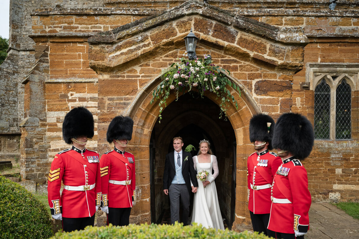 Bride and groom coming out of church through a military guard of honour