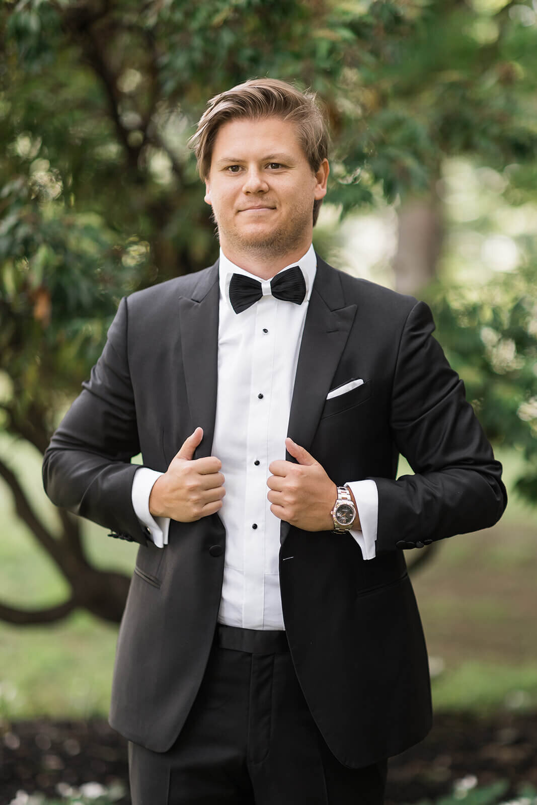Groom wearing a black tuxedo for Long Island wedding, New York
