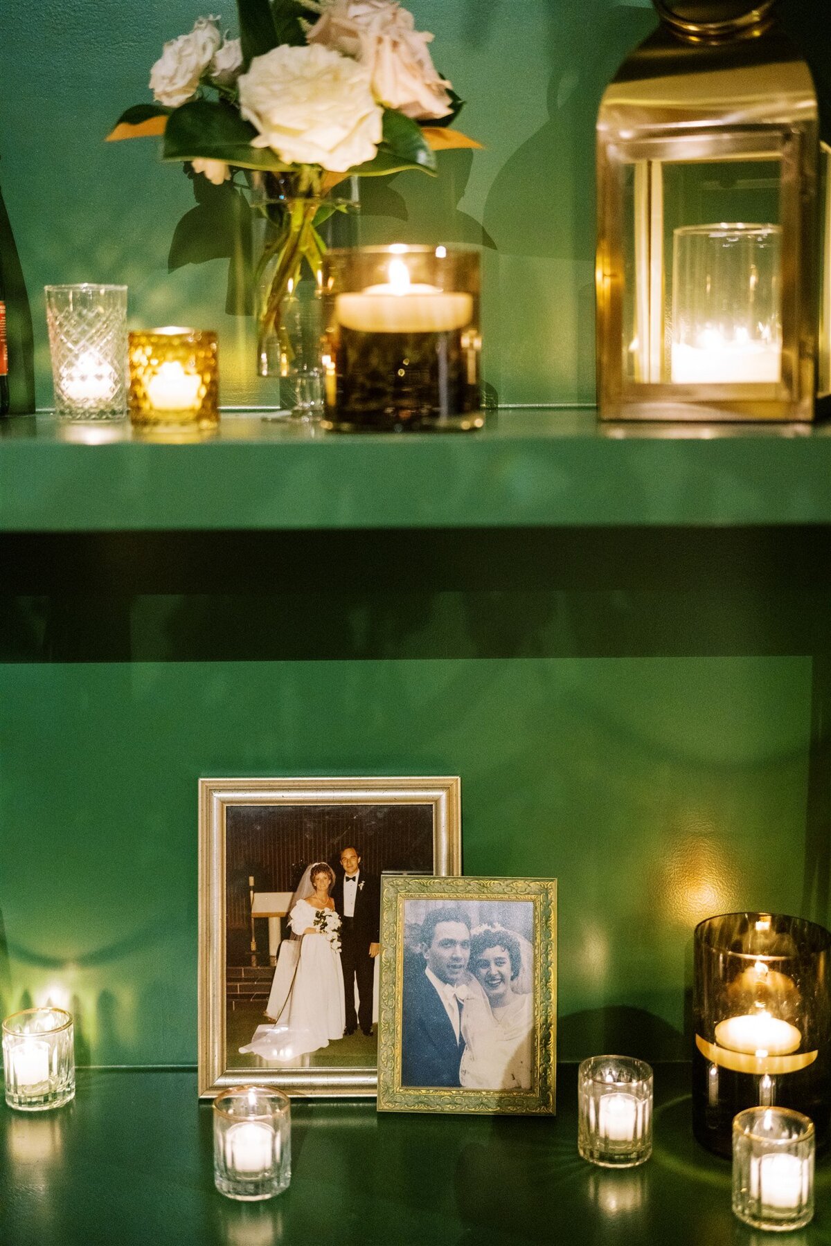A close up of old photos under candle light. 