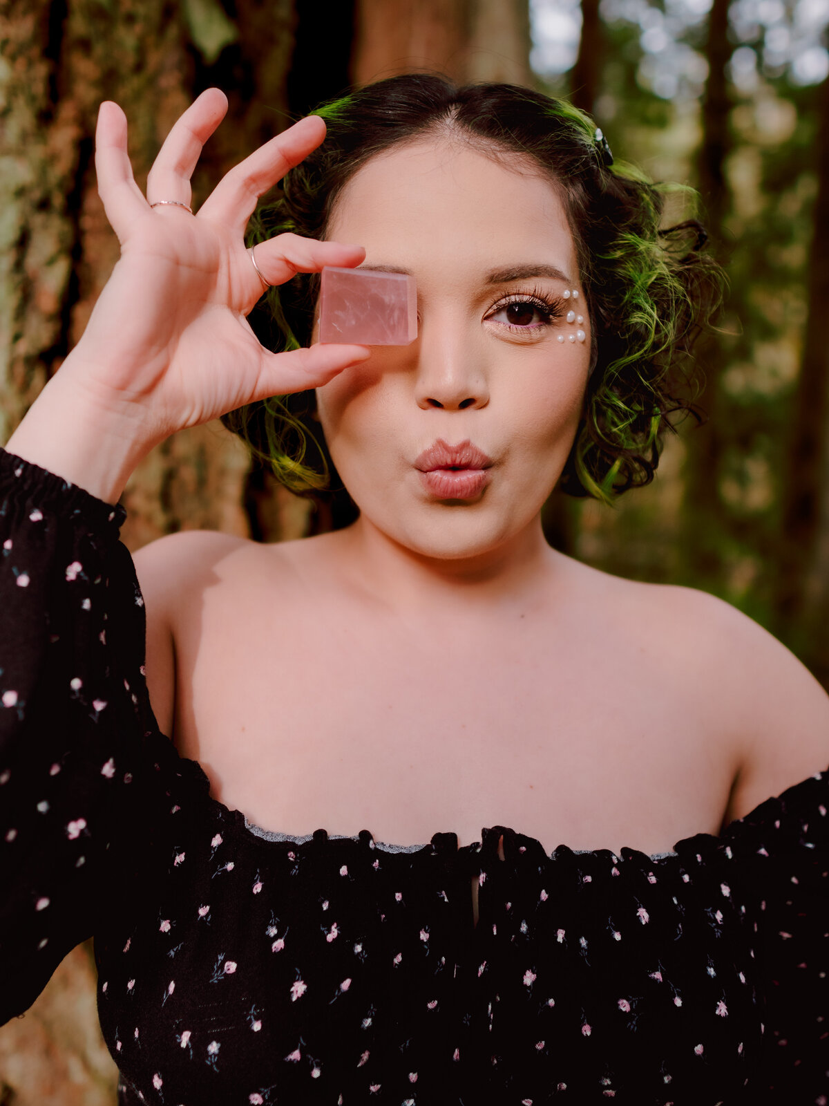Young woman making a playful expression with one eye covered – creative portrait by Mewphotovideo