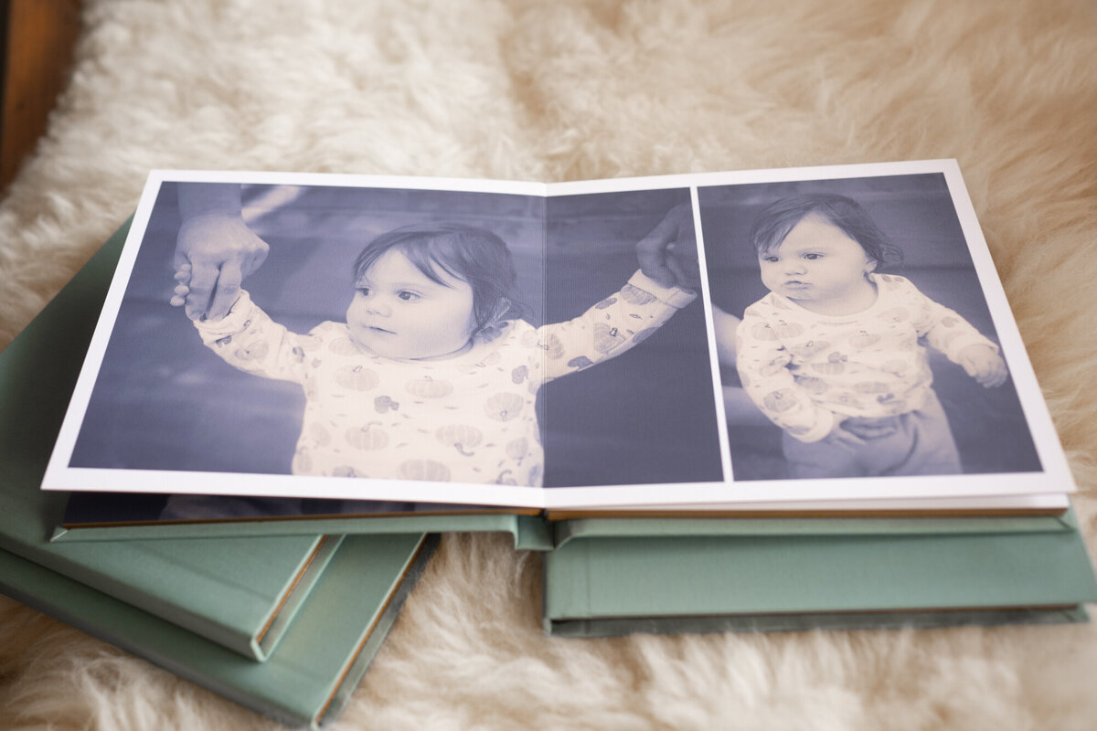 An open small fine art photo album on copies on blanket